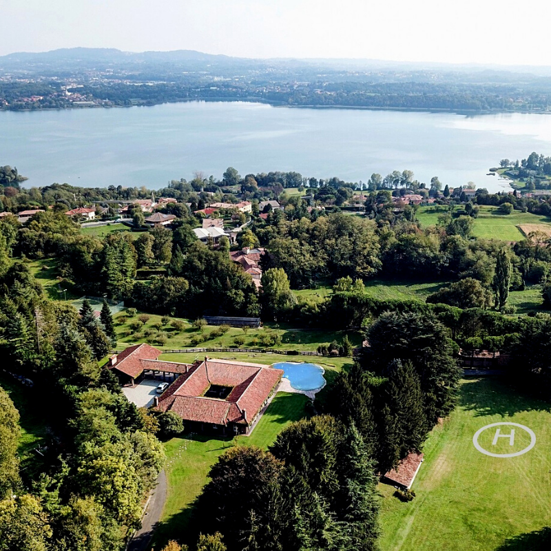 Aerial view of the lakefront property woth a simple helicopter pad in Eupilio, Lombardy, Italy